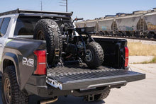 Load image into Gallery viewer, DV8 Offroad Truck Bed Universal Tire Carrier & Accessory Mount