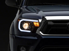 Load image into Gallery viewer, Raxiom 12-15 Toyota Tacoma Axial Projector Headlights w/ SEQL LED Bar- Blk Housing (Clear Lens) Headlights Raxiom