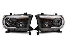 Load image into Gallery viewer, Raxiom 07-13 Toyota Tundra Axial Projector Headlights w/ SEQL LED Bar- Blk Housing (Clear Lens) Headlights Raxiom
