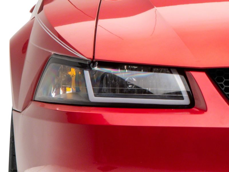 Raxiom 99-04 Ford Mustang Axial Series Headlights w/ Sequential LED Bar- Blk Housing (Clear Lens) Headlights Raxiom