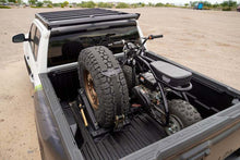 Load image into Gallery viewer, DV8 Offroad Truck Bed Universal Tire Carrier &amp; Accessory Mount

