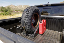 Load image into Gallery viewer, DV8 Offroad Truck Bed Universal Tire Carrier &amp; Accessory Mount
