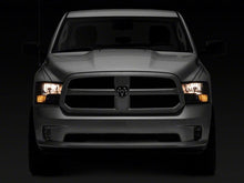 Load image into Gallery viewer, Raxiom 09-18 Dodge RAM 1500 Axial Series Euro Style Headlights w/ Dual Bulb Blk Housing (Clear Lens) Headlights Raxiom
