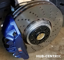 Load image into Gallery viewer, Burger Motorsports BMW G chassis wheel spacers installed on drilled brake rotor with blue brake caliper
