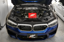 Load image into Gallery viewer, JB4 tuner S63 F9x M5 installed on a blue BMW with engine visible in the open hood
