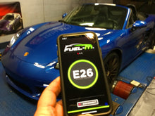 Load image into Gallery viewer, JB4 tuner for Porsche 718 shown on smartphone screen with blue Porsche 718 in background
