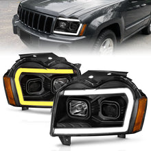 Load image into Gallery viewer, ANZO 2005-2007 Jeep Grand Cherokee Projector Headlights w/ Light Bar Switchback Black Housing Headlights ANZO
